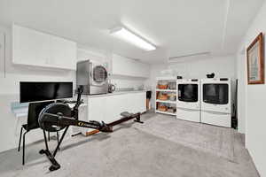 Laundry area featuring washer and dryer and cabinets