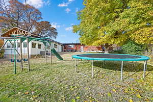 View of yard featuring a trampoline