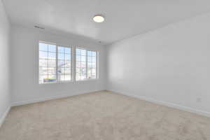 Carpeted empty room featuring a textured ceiling