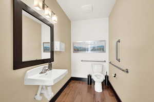 Bathroom featuring hardwood / wood-style floors and toilet