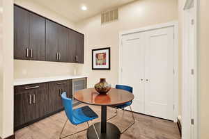 Dining room with wine cooler and light hardwood / wood-style flooring