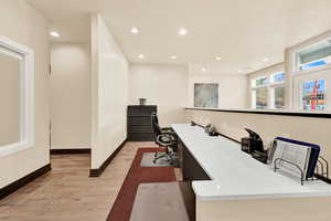 Home office featuring sink and light wood-type flooring