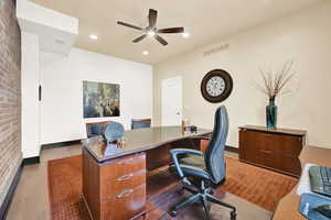 Home office featuring light hardwood / wood-style flooring and ceiling fan