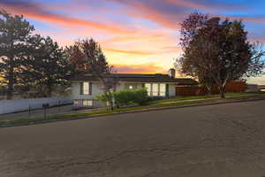 View of front of home featuring solar panels and a fenced front yard