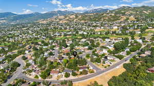 Aerial overview of property's location with nearby suburban area and mountains