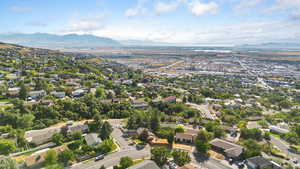 Aerial overview of property's location with mountains and nearby suburban area