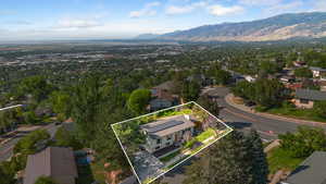 Aerial perspective of suburban area with mountains and property parcel outlined
