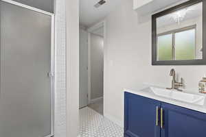 Updated bath with vanity and a shower stall