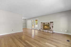 Spacious living room with cozy fireplace and hardwood floors