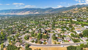 Aerial view of property's location with nearby suburban area and a mountain backdrop