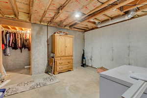 Basement featuring white refrigerator