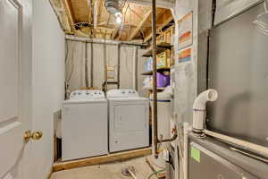 Washroom featuring washing machine and dryer