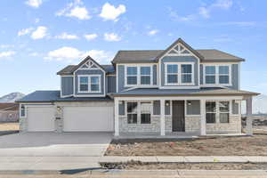 View of front of property with a porch and a garage