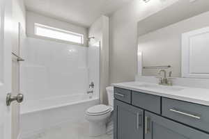 Full bathroom with vanity, tub / shower combination, and toilet