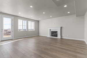 Unfurnished living room featuring a textured ceiling and light wood-type flooring