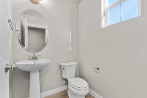 Bathroom featuring sink, hardwood / wood-style flooring, and toilet