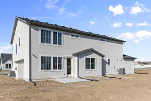 Back of property featuring a patio and central AC unit