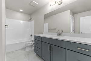 Full bathroom with vanity, bathtub / shower combination, and toilet