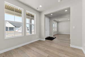 Entrance foyer with light wood-type flooring