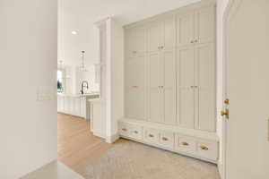 Mudroom with light hardwood / wood-style floors