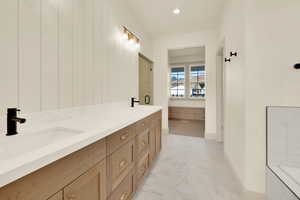 Bathroom with vanity and a shower with shower door