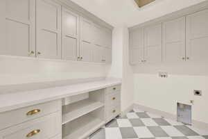 Laundry room featuring washer hookup, electric dryer hookup, cabinets, and a skylight