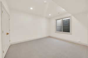 Empty room featuring light colored carpet