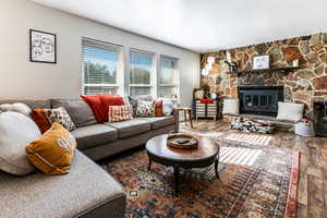 Living room with a fireplace and hardwood / wood-style flooring