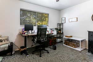 Office with carpet flooring and ceiling fan