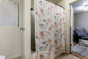 Bathroom featuring tile patterned flooring and a textured ceiling