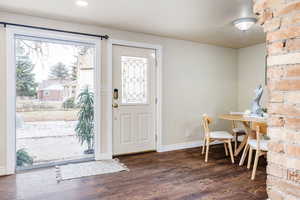 Entrance foyer featuring a textured ceiling and dark hardwood / wood-style flooring