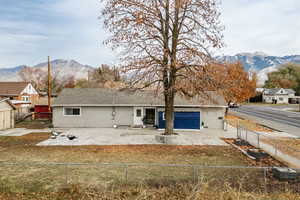 View of front of home featuring a mountain view and a front yard