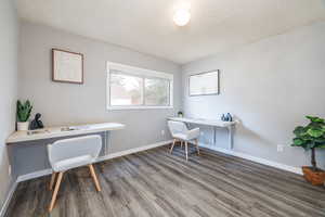 Office space featuring built in desk and wood-type flooring