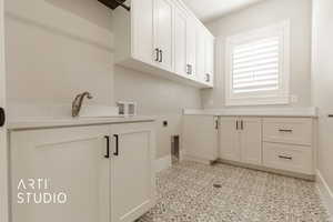 Laundry area featuring electric dryer hookup, cabinets, and hookup for a washing machine