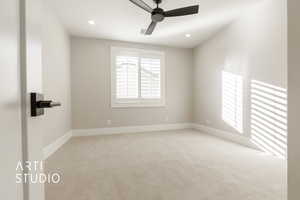 Spare room featuring ceiling fan and light colored carpet