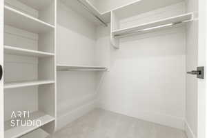 Spacious closet with light colored carpet