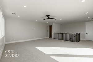 Carpeted spare room featuring ceiling fan