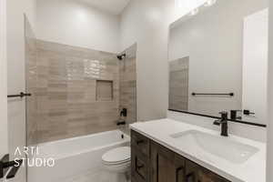 Full bathroom featuring vanity, toilet, and tiled shower / bath