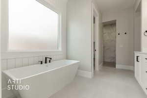 Bathroom featuring tile patterned floors, vanity, and plus walk in shower