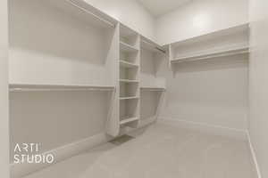 Spacious closet featuring carpet flooring