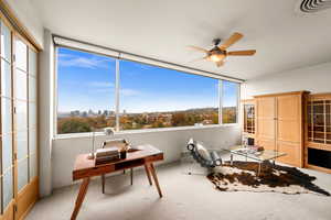 Sunroom featuring ceiling fan and a healthy amount of sunlight