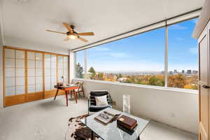 Sunroom / solarium featuring ceiling fan