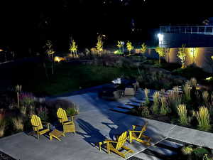 Evening view of the common space featuring patio areas, and water-wise planting.