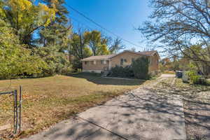 View of side of home with a lawn