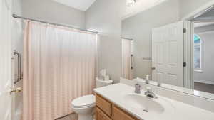 Bathroom with tile patterned floors, vanity, and toilet