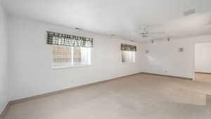 Unfurnished room with carpet flooring and ceiling fan