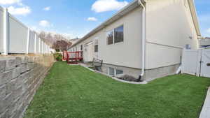 View of home's exterior featuring a lawn and a mountain view