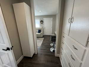 Corridor with dark wood-type flooring