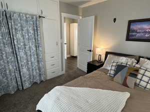 Bedroom featuring dark carpet