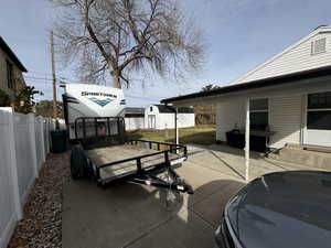 View of patio featuring a shed and grilling area